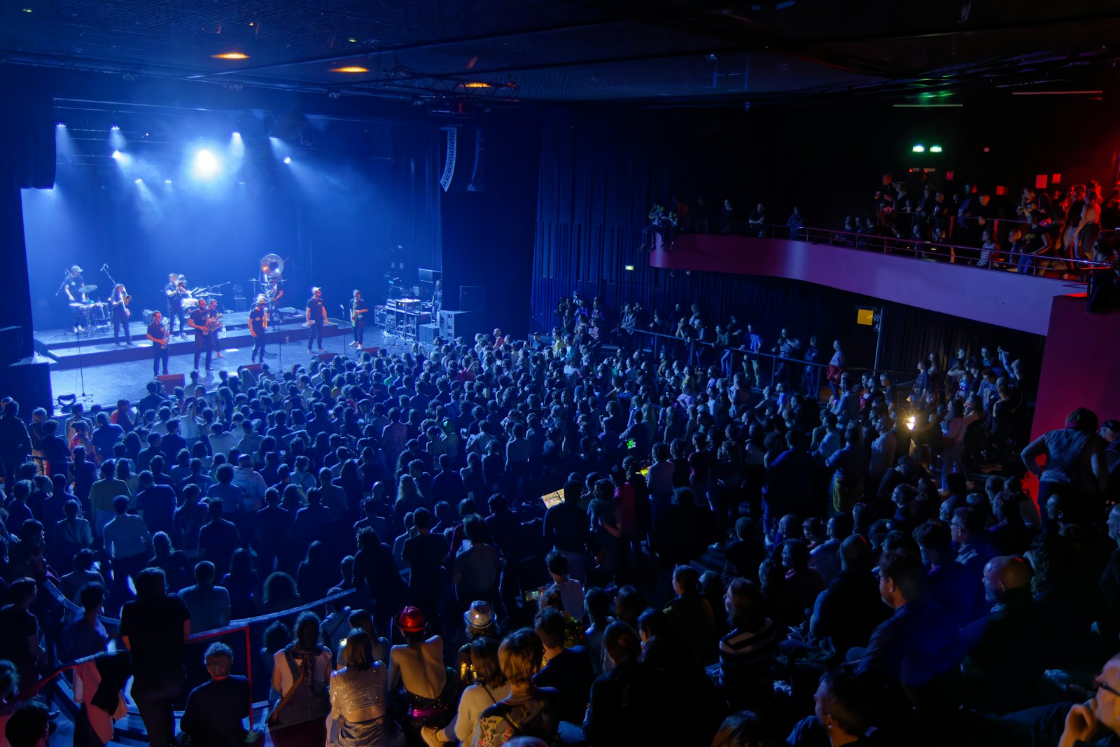 A band performs on stage for a large audience